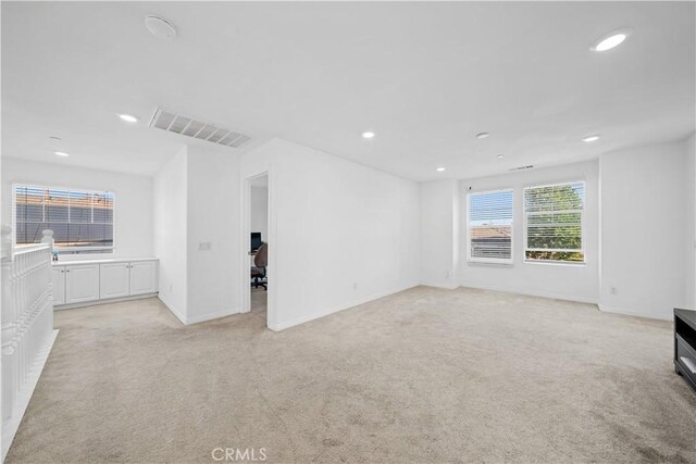 13126 Flagstaff Dr, Rancho Cucamonga, CA 91739 - unfurnished living room featuring light colored carpet, recessed lighting, and a desk