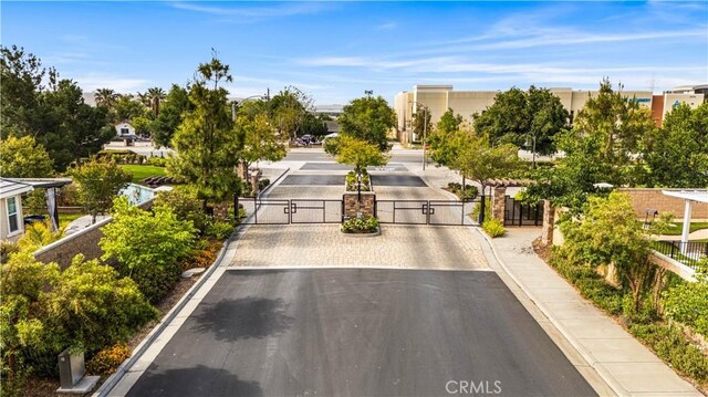 13126 Flagstaff Dr, Rancho Cucamonga, CA 91739 - view of asphalt street with a gate, curbs, sidewalks, and a gated entry