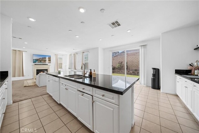 13126 Flagstaff Dr, Rancho Cucamonga, CA 91739 - kitchen featuring dishwasher, light tile patterned flooring, a lit fireplace, light carpet, and open floor plan