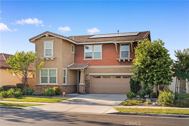 13126 Flagstaff Dr, Rancho Cucamonga, CA 91739 - view of front of home with roof mounted solar panels, driveway, a garage, stucco siding, and stone siding