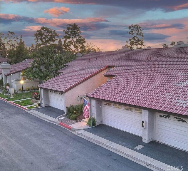 1531 Corte Caballo Unit 33, Upland, CA 91786 - view of front of house with stucco siding and a tile roof
