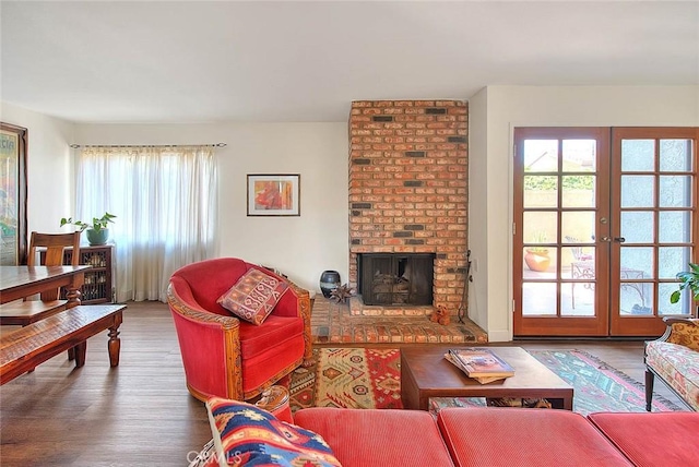 1531 Corte Caballo Unit 33, Upland, CA 91786 - living room featuring wood finished floors, a brick fireplace, and french doors