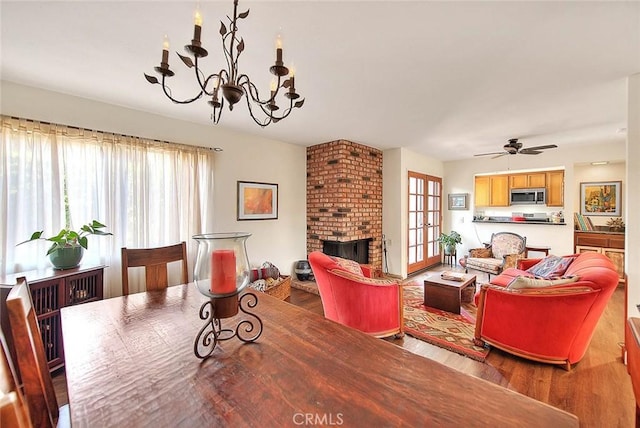 1531 Corte Caballo Unit 33, Upland, CA 91786 - living room featuring wood finished floors, plenty of natural light, a chandelier, and a fireplace