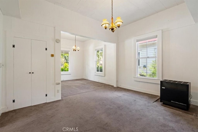 863 Chorro St, San Luis Obispo, CA 93401 - unfurnished dining area with a chandelier, heating unit, and carpet