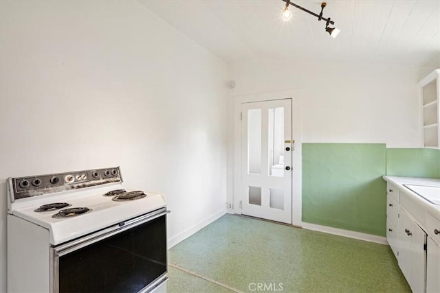 863 Chorro St, San Luis Obispo, CA 93401 - kitchen featuring white electric stove, white cabinetry, rail lighting, light countertops, and lofted ceiling