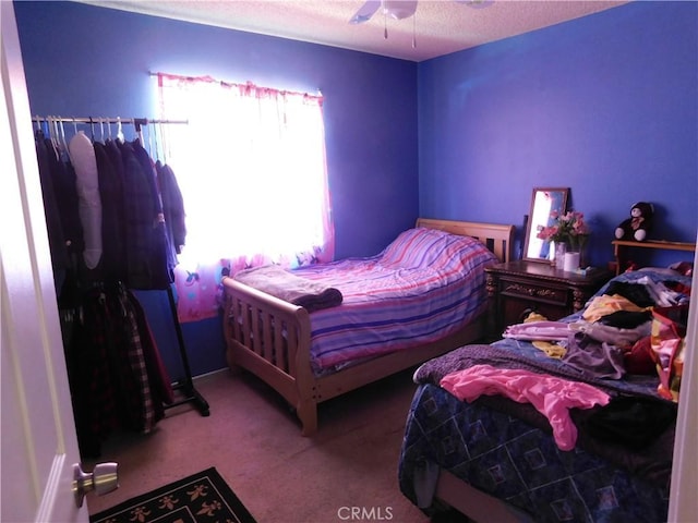 8372 Dogwood Ave, California City, CA 93505 - carpeted bedroom with a textured ceiling and a ceiling fan