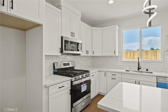 1761 Drayer Dr, Paradise, CA 95969 - kitchen with appliances with stainless steel finishes, white cabinets, light stone counters, backsplash, and recessed lighting
