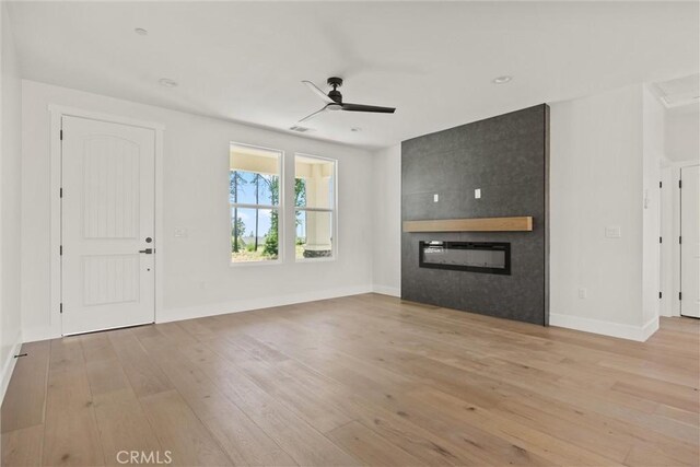 1761 Drayer Dr, Paradise, CA 95969 - unfurnished living room featuring a large fireplace, a ceiling fan, light wood-type flooring, and recessed lighting