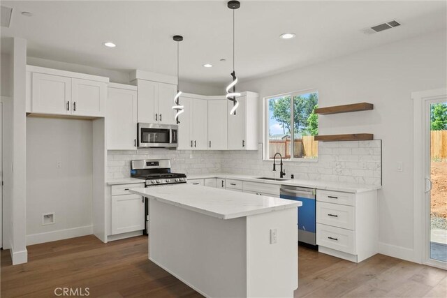 1761 Drayer Dr, Paradise, CA 95969 - kitchen with stainless steel appliances, white cabinets, healthy amount of natural light, tasteful backsplash, and recessed lighting