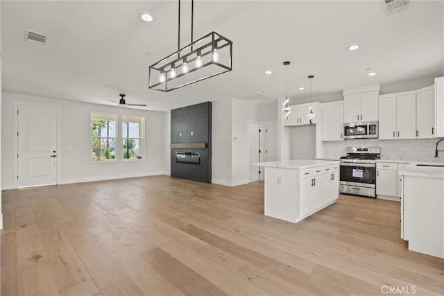 1761 Drayer Dr, Paradise, CA 95969 - kitchen with stainless steel appliances, open floor plan, ceiling fan, light wood finished floors, and recessed lighting