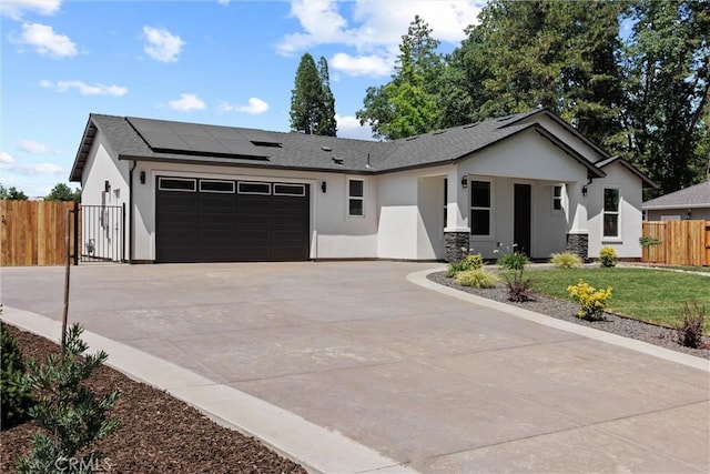 1761 Drayer Dr, Paradise, CA 95969 - ranch-style home with a garage, stucco siding, driveway, roof mounted solar panels, and a gate