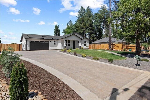 1761 Drayer Dr, Paradise, CA 95969 - ranch-style home featuring an attached garage, concrete driveway, solar panels, and stucco siding