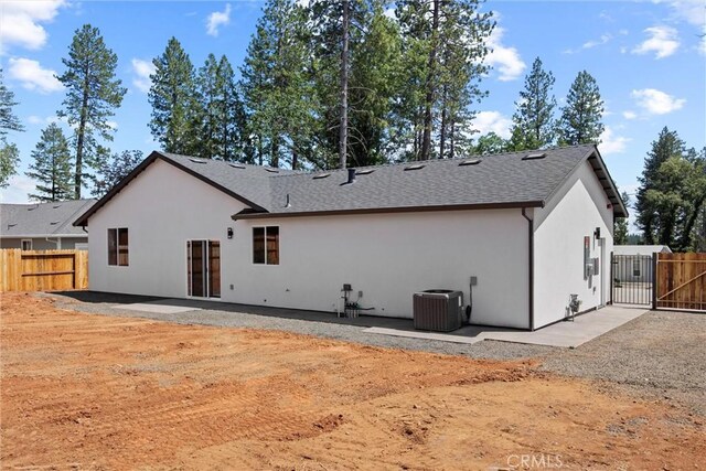 1761 Drayer Dr, Paradise, CA 95969 - back of property featuring a gate, stucco siding, a patio area, and a shingled roof