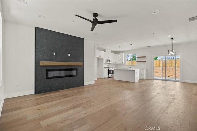 1761 Drayer Dr, Paradise, CA 95969 - unfurnished living room with a ceiling fan, light wood-type flooring, recessed lighting, and a large fireplace