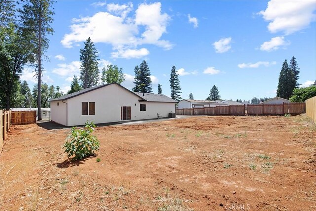 1761 Drayer Dr, Paradise, CA 95969 - rear view of property with a fenced backyard and stucco siding