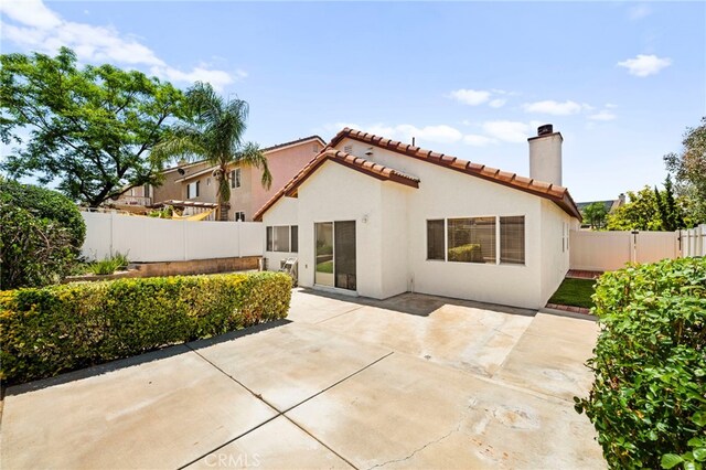 33546 Maplewood Ct, Temecula, CA 92592 - rear view of house with a tile roof, a fenced backyard, a patio area, and a chimney