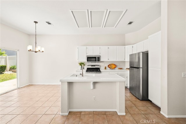 33546 Maplewood Ct, Temecula, CA 92592 - kitchen featuring stainless steel appliances, tile counters, light tile patterned flooring, and white cabinets