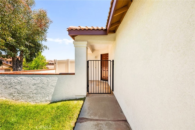 33546 Maplewood Ct, Temecula, CA 92592 - property entrance with stucco siding, a gate, and a tile roof