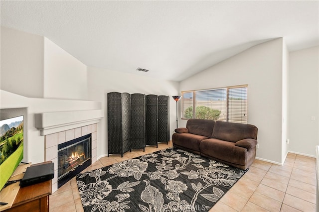 33546 Maplewood Ct, Temecula, CA 92592 - living room featuring light tile patterned floors, lofted ceiling, and a tiled fireplace