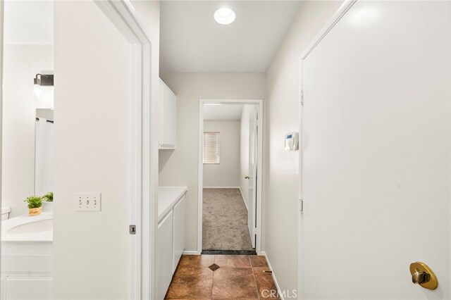 33546 Maplewood Ct, Temecula, CA 92592 - hallway with dark tile patterned floors and dark colored carpet