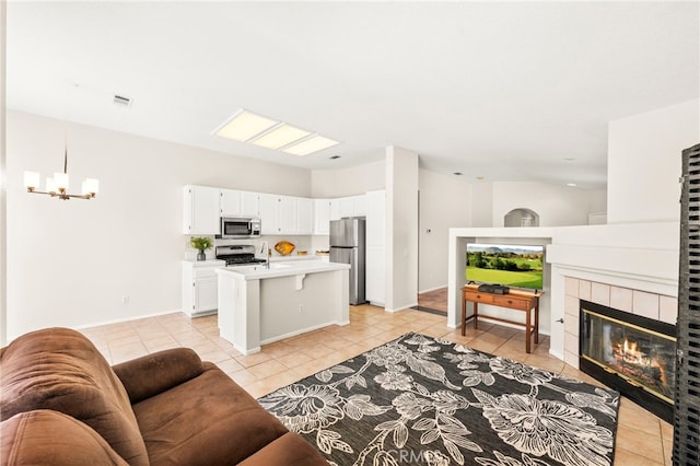 33546 Maplewood Ct, Temecula, CA 92592 - living room featuring light tile patterned floors, a tile fireplace, and a chandelier
