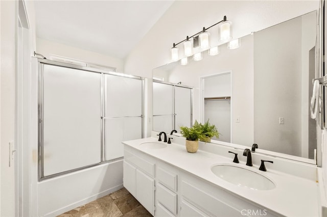 33546 Maplewood Ct, Temecula, CA 92592 - bathroom featuring double vanity, enclosed tub / shower combo, and stone finish floors