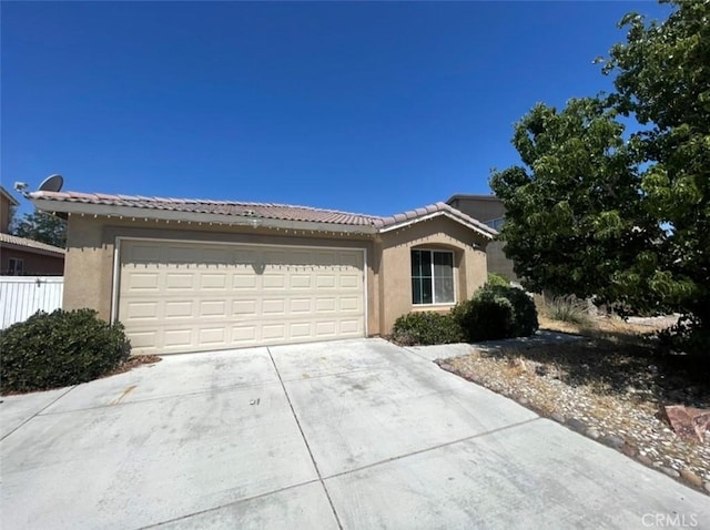 13590 Fox Point Rd, Victorville, CA 92392 - view of front of home featuring concrete driveway, stucco siding, a garage, and a tile roof