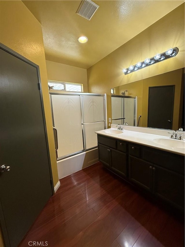 13590 Fox Point Rd, Victorville, CA 92392 - full bath with wood finished floors, shower / bath combination with glass door, and double vanity