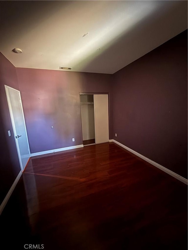 13590 Fox Point Rd, Victorville, CA 92392 - unfurnished bedroom with wood finished floors and a closet