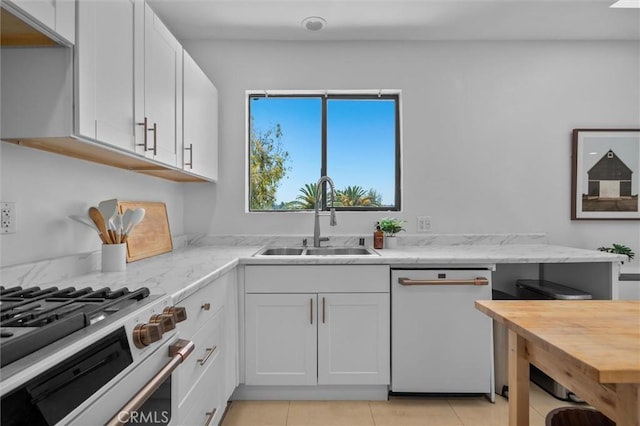 4698 Morro Dr, Woodland Hills, CA 91364 - kitchen with dishwasher, white cabinets, high end stainless steel range oven, butcher block counters, and light tile patterned floors