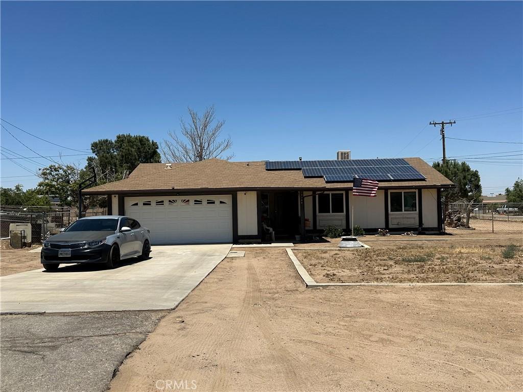 14796 Walnut St, Hesperia, CA 92345 - ranch-style house featuring a garage, driveway, solar panels, and roof with shingles