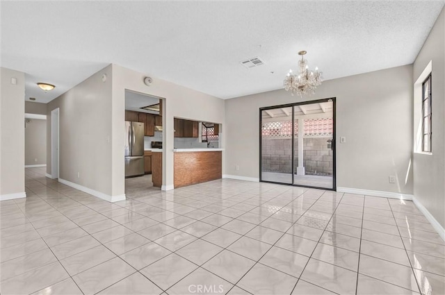 10102 Rio Hondo, El Monte, CA 91733 - unfurnished living room with a chandelier, light tile patterned flooring, and a textured ceiling