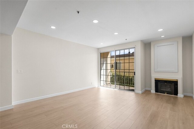 4348 Mammoth Ave Unit 102, Sherman Oaks, CA 91423 - unfurnished living room with light wood finished floors, a glass covered fireplace, and recessed lighting