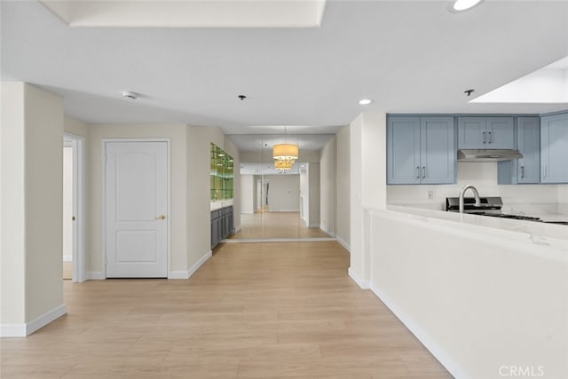 4348 Mammoth Ave Unit 102, Sherman Oaks, CA 91423 - kitchen with under cabinet range hood, recessed lighting, light wood finished floors, light countertops, and stainless steel stove