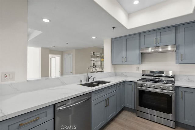 4348 Mammoth Ave Unit 102, Sherman Oaks, CA 91423 - kitchen featuring appliances with stainless steel finishes, under cabinet range hood, gray cabinetry, light stone countertops, and recessed lighting