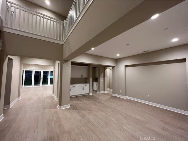 22046 Fig Tree Ln, Chatsworth, CA 91311 - unfurnished living room featuring light wood-style floors, recessed lighting, and a high ceiling