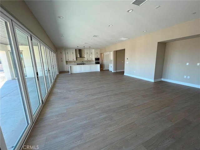 22046 Fig Tree Ln, Chatsworth, CA 91311 - unfurnished living room with light wood-type flooring and recessed lighting