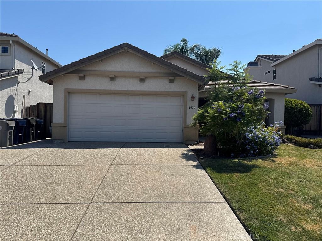 5330 Alvoca Way, Sacramento, CA 95835 - view of front facade featuring driveway, stucco siding, a front lawn, and an attached garage