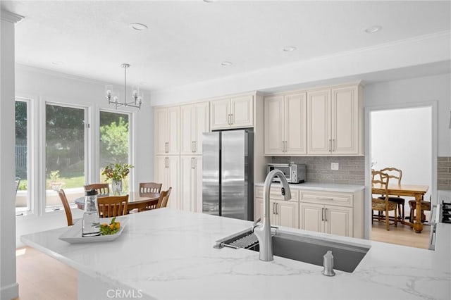 4324 Park Verdi, Calabasas, CA 91302 - kitchen featuring freestanding refrigerator, tasteful backsplash, hanging light fixtures, a chandelier, and crown molding