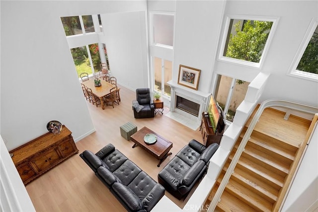 4324 Park Verdi, Calabasas, CA 91302 - living room featuring plenty of natural light, wood finished floors, a fireplace, and a towering ceiling