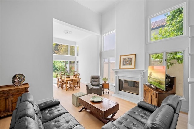 4324 Park Verdi, Calabasas, CA 91302 - living area featuring a towering ceiling, a tiled fireplace, and wood finished floors