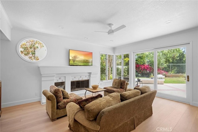 4324 Park Verdi, Calabasas, CA 91302 - living room with a ceiling fan, ornamental molding, light wood-type flooring, plenty of natural light, and a textured ceiling