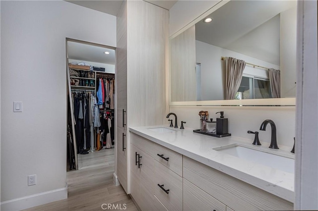 9418 Via Patricia Unit 30, Burbank, CA 91504 - bathroom with double vanity, wood finished floors, recessed lighting, and a walk in closet