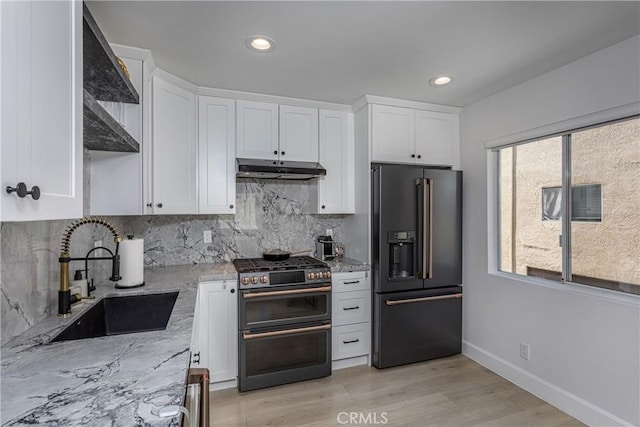 9418 Via Patricia Unit 30, Burbank, CA 91504 - kitchen featuring high quality fridge, double oven range, under cabinet range hood, white cabinetry, and light stone counters