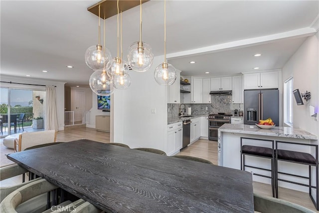 9418 Via Patricia Unit 30, Burbank, CA 91504 - dining space featuring light wood finished floors, recessed lighting, and a chandelier