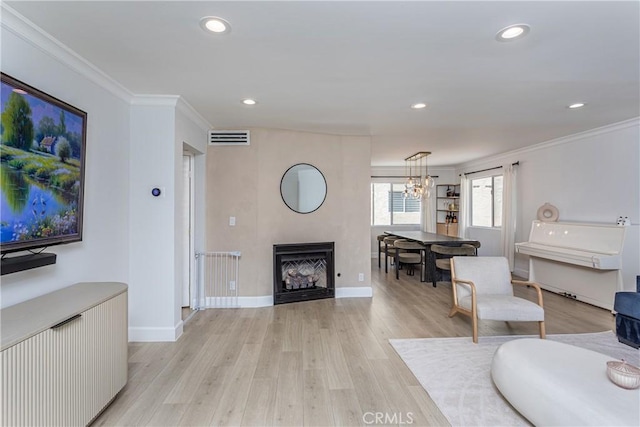 9418 Via Patricia Unit 30, Burbank, CA 91504 - living room featuring ornamental molding, light wood-style flooring, recessed lighting, a chandelier, and a fireplace