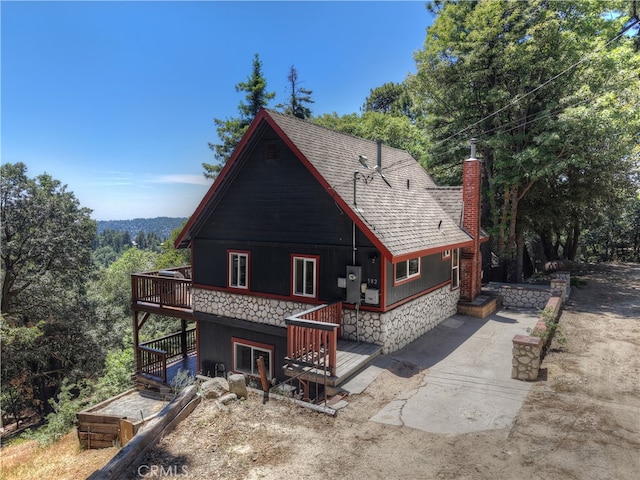 582 Sunset View Rd, Twin Peaks, CA 92391 - back of property featuring a shingled roof, a chimney, and a deck