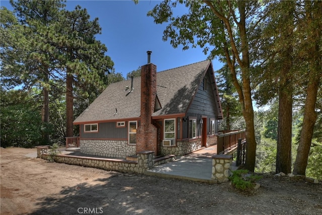 582 Sunset View Rd, Twin Peaks, CA 92391 - rear view of property with stone siding, a patio, a chimney, a shingled roof, and a deck