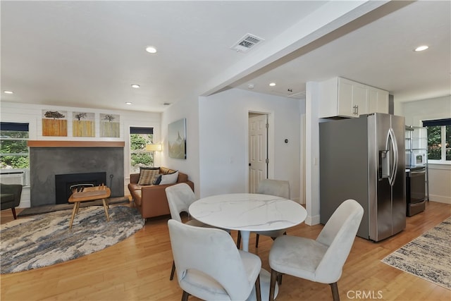 582 Sunset View Rd, Twin Peaks, CA 92391 - dining room with light wood-type flooring, recessed lighting, and a fireplace with raised hearth