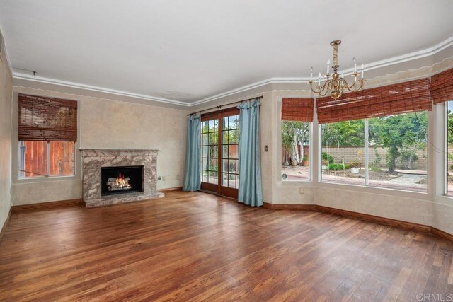 4556 Mariners Bay, Oceanside, CA 92057 - unfurnished living room featuring wood finished floors, a chandelier, ornamental molding, and a high end fireplace